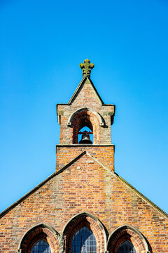 Church bell tower with cross UK