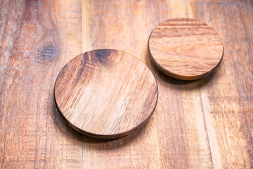 Round wooden jar's cap over the wooden background