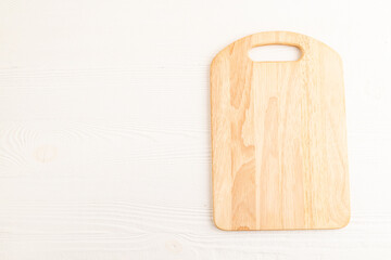 Empty rectangular wooden cutting board on white wooden. Top view, copy space