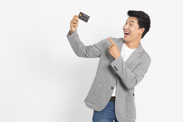 Young Asian businessman showing credit card isolated on white background