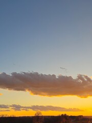 A sunset with clouds and blue sky