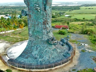 Aerial view of the Statue of Columbus, surrounded by lush green vegetation in Arecibo, Puerto Rico