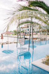 Hanging chair on stands in the pool of a hotel complex