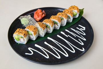 Variety of sushi rolls are presented on a plate, showcasing the colorful and fresh ingredients.