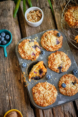 Carrot muffin with blueberries and walnuts.  Wooden background. Top view. 