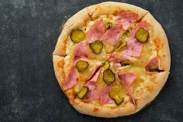Pizza. Traditional Bacon pizza with ham, mushrooms, pickled cucumber and cheese and cooking ingredients tomatoes basil on wooden table backgrounds. Italian Traditional food. Top view. Mock up.
