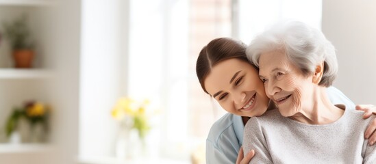Obraz na płótnie Canvas Nurse hugging elderly patients during visit at home