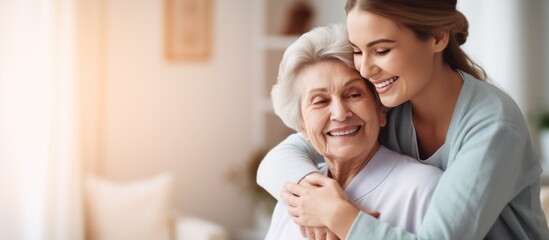 Nurse hugging elderly patients during visit at home