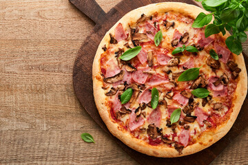 Pizza. Traditional Bacon pizza with ham, mushrooms, pickled cucumber and cheese and cooking ingredients tomatoes basil on wooden table backgrounds. Italian Traditional food. Top view. Mock up.