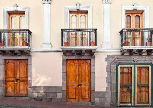 Street view of an old colonial building facade in Quito, Ecuador.