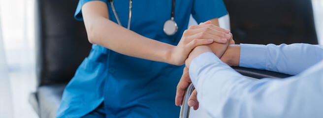 Cropped shot of a female nurse hold her senior patient's hand. Giving Support. Doctor helping old patient with Alzheimer's disease. Female carer holding hands of senior man - obrazy, fototapety, plakaty