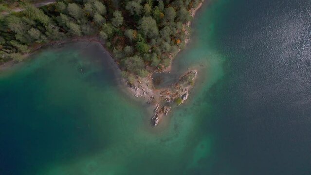 drone looking down nadir rising up from a lake
