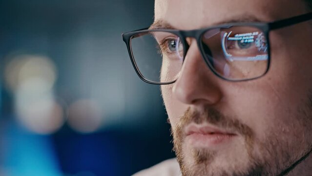 Close up shot of man wearing glasses watching news. Reflection in eyeglasses russian aggression against Ukraine. First cadres in mass media about ukrainian crisis