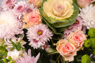 Bouquet of beautiful flowers with pink roses, brassica flower, chrysanthemum and freesia flower.