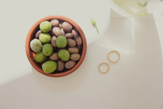 olives and wedding rings on a table