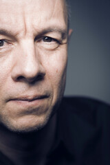 Studio shot portrait man 50s pensive expression