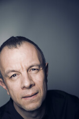 Studio shot portrait man 50s pensive expression