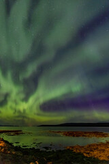 Impressive and breathtaking show of Aurora Borealis or The Northern Lights over the Atlantic Ocean...