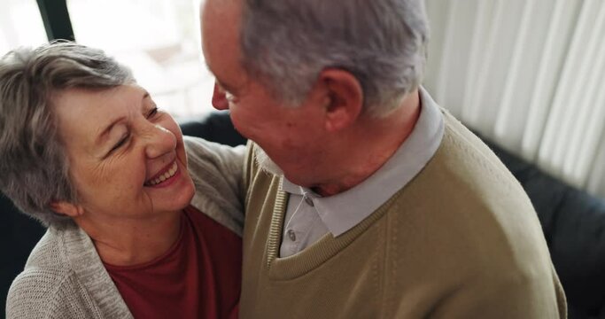 Dance, love and an elderly couple in their home for playful romance together during retirement. Smile, relax or funny with a happy senior man and woman moving to music in a living room closeup