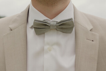 close up of the grooms tie in a beige suit