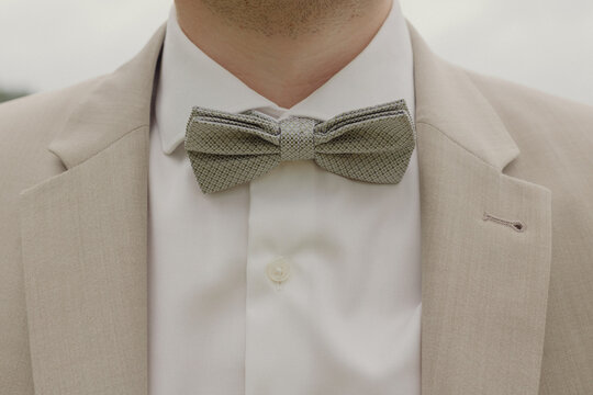 close up of the grooms tie in a beige suit