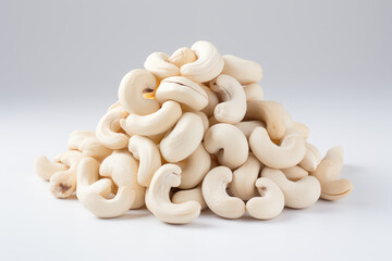 A pile of cashews on a white surface