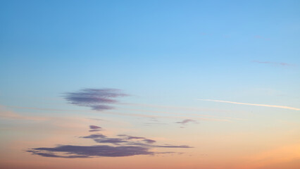 Very gentle romantic pink clouds in the dawn sky. Tender mood sunrise sky image.