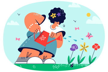 Smiling girl watering flowers