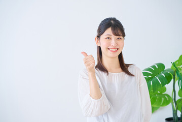 良いねのポーズをする若い女性