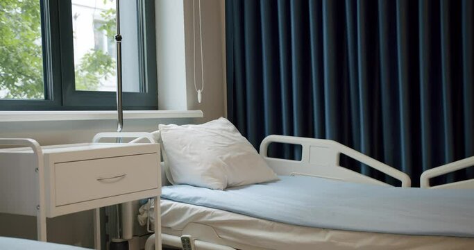 Recovery room with comfortable bed in clinic. Modern interior of empty hospital room.