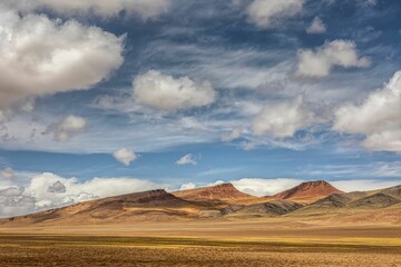 Scenic landscape of the Ali region of Tibet, with majestic mountains stretching to the horizon.