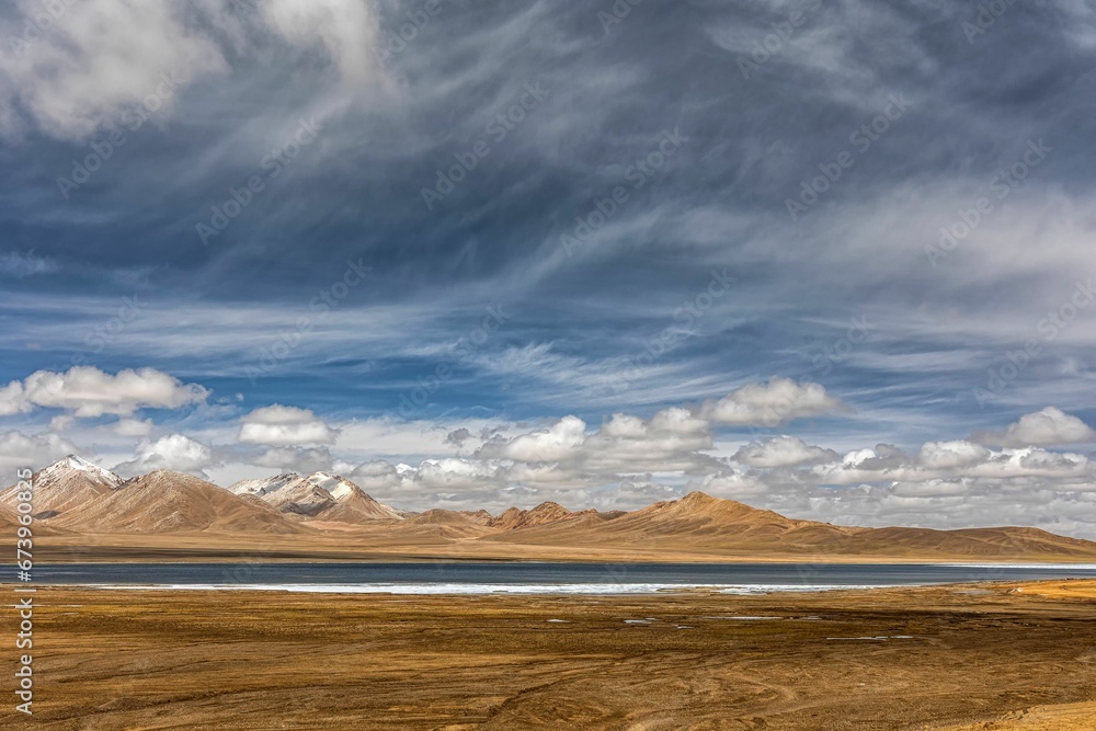 Wall mural Stunning landscape in the Ali region of Tibet, with majestic mountains and a tranquil blue lake