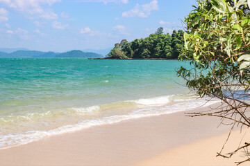 White sandy beach and clear clear turquoise sea, tropical paradise, time for vacation and relaxation.