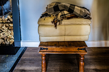 Wooden stool, seats, blanket. Firewood. Dirty room.