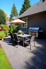 Relaxation area in the backyard of the villa, patio with grill, table and chairs for guests.