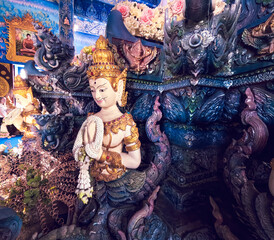 Hand-carved wood idol mythical inside Wat Rong Suea Ten Blue Temple at Chiang Rai Thailand