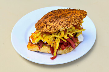 Close-up shot of Izmir's famous Turkish Traditional Kumru Sandwich, Çeşme Kumru , ingredients ready to eat salami, sucuk , tomato, cheddar cheese and fried cheese. Yengen eritme karisik sandvic.