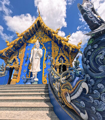 Large Buddha statue on façade of Wat Rong Suea Ten Blue Temple at Chiang Rai Thailand - obrazy, fototapety, plakaty