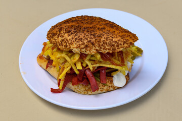 Close-up shot of Izmir's famous Turkish Traditional Kumru Sandwich, Çeşme Kumru , ingredients ready to eat salami, sucuk , tomato, cheddar cheese and fried cheese. Yengen eritme karisik sandvic.