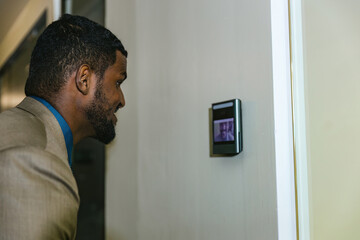 Fototapeta premium Man using face scanner to unlock door in office building. Access control facial recognition system. Biometric admittance control device for security system. Biometric admittance control device