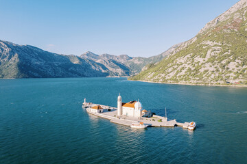 Church of Our Lady of the Rocks on the island of Gospa od Skrpjela. Bay of Kotor, Montenegro. Drone - obrazy, fototapety, plakaty