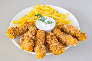 Fried Chicken breast hot crispy strips crunchy chicken tenders  isolated on white background.Nuggets isolated on white background on a plate