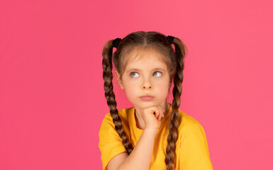 Pensive Little Girl Looking Aside At Copy Space And Touching Chin