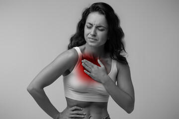 Woman with chest pain touching her breast