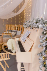 Christmas tree with white flowers and a white piano.