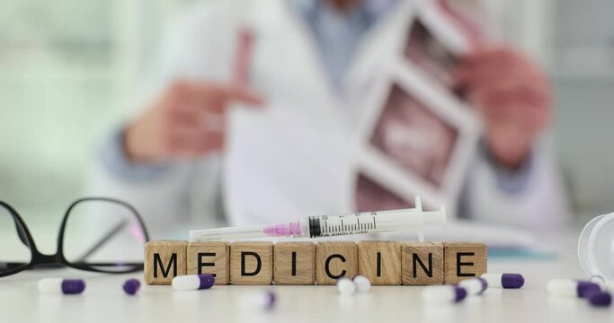 Word medicine is tablet syringe and doctor is examining X-ray image