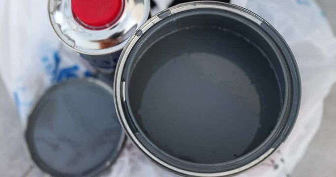 Open can of gray black with paint inside
