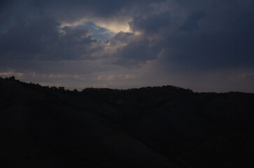 Dark sky with sunshine through the clouds