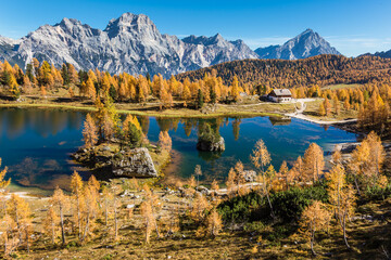 Autumn scenery at lake Federa in Dolomites mountains.