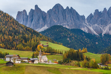 Famous place Santa Maddalena village with Dolomites mountains in background, Val di Funes valley